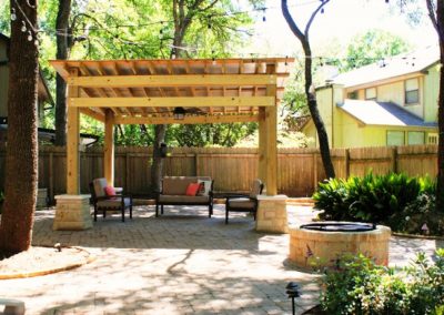 Pergola made of wood, rock columns and rock firepit